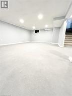 Finished basement featuring stairway and baseboards - 