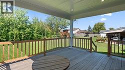 Deck featuring a playground and a fenced backyard - 