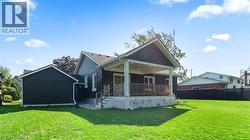 Rear view of house with board and batten siding and a patio - 