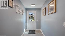Doorway featuring baseboards and tile patterned flooring - 