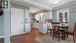 Dining room with light wood-style flooring and baseboards - 