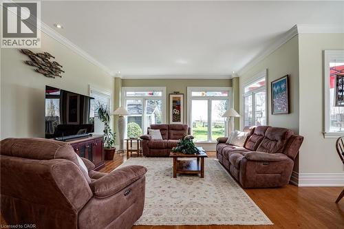 Living area with crown molding, wood finished floors, and healthy amount of natural light - 849 Beach Boulevard, Hamilton, ON - Indoor Photo Showing Living Room