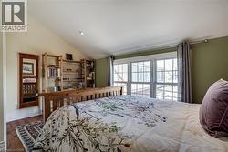 Bedroom #2 featuring lofted ceiling, dark wood-style floors, and recessed lighting - 