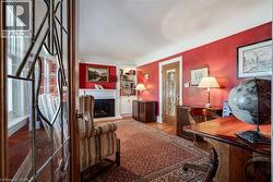 Office area featuring a fireplace with raised hearth - 