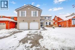 Traditional-style house with brick siding and a garage - 