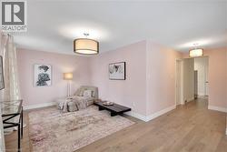 Living area featuring baseboards and light wood-type flooring - 