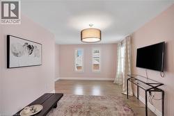 Unfurnished living room with light wood-style floors and baseboards - 