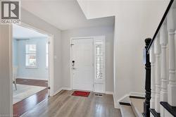 Entryway featuring light wood-style floors and stairs - 