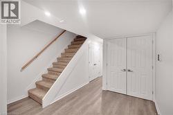 Stairs with wood finished floors and baseboards - 
