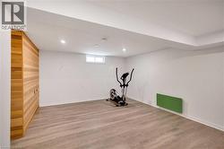 Workout room with light wood-style flooring - 