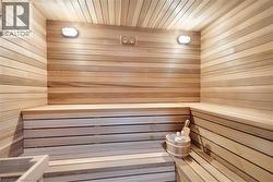 Relaxing sauna / steam room featuring wood walls and wood ceiling - 