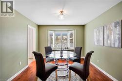 Dining area with dark wood finished floors and baseboards - 