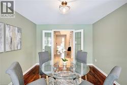 Dining space featuring french doors and wood finished floors - 