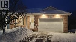 View of front of home featuring driveway and a garage - 