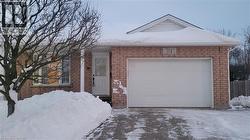 View of front facade with brick siding and driveway - 