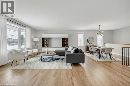 Living room with a chandelier, healthy amount of natural light, and light wood-type flooring - 114 Glencliffe Court, Kitchener, ON - Indoor Photo Showing Living Room