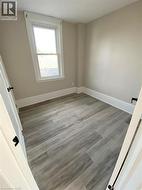 Unfurnished room featuring light wood finished floors and baseboards - 