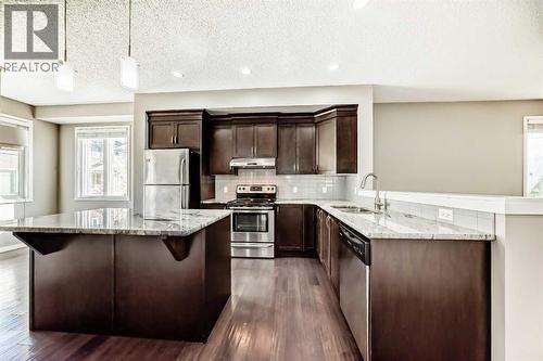 238 Panatella  Nw, Calgary, AB - Indoor Photo Showing Kitchen With Upgraded Kitchen