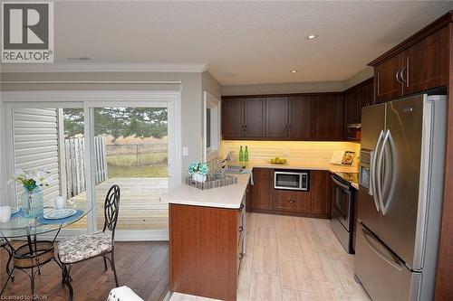 Kitchen featuring stainless steel appliances, light countertops, recessed lighting, light wood finished floors, and tasteful backsplash - 41 Sister Kern Terrace, Hamilton, ON - Indoor Photo Showing Kitchen