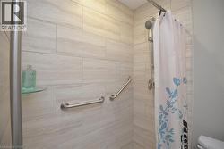 Bathroom featuring a stall shower and toilet - 