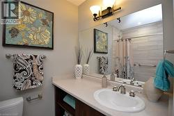 Bathroom featuring vanity and a tile shower - 
