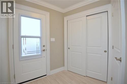 Doorway to outside with ornamental molding and wood finished floors - 41 Sister Kern Terrace, Hamilton, ON - Indoor Photo Showing Other Room