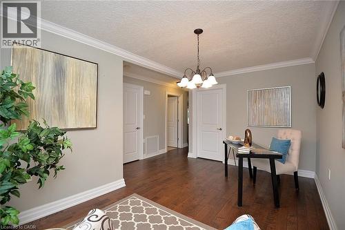 Home office with crown molding, a textured ceiling, dark wood finished floors, and a chandelier - 41 Sister Kern Terrace, Hamilton, ON - Indoor