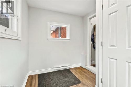 Washroom with light wood-style floors and baseboard heating - 557 Lake Street, St. Catharines, ON - Indoor Photo Showing Other Room