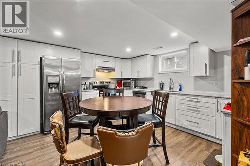Kitchen with appliances with stainless steel finishes, white cabinets, light wood-style flooring, and recessed lighting - 557 Lake Street, St. Catharines, ON - Indoor