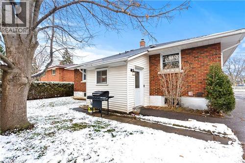 Snow covered house with brick siding and a chimney - 557 Lake Street, St. Catharines, ON - Outdoor