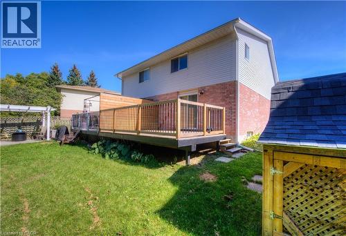 Rear view of house with brick siding and a deck - 236 Bankside Drive, Kitchener, ON - Outdoor With Deck Patio Veranda With Exterior