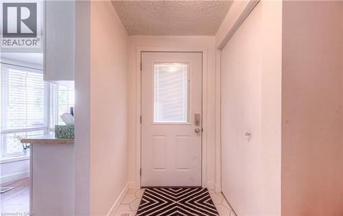 Entryway with plenty of natural light and a textured ceiling - 236 Bankside Drive, Kitchener, ON - Indoor Photo Showing Other Room
