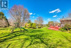 View of yard featuring a deck and playground community - 