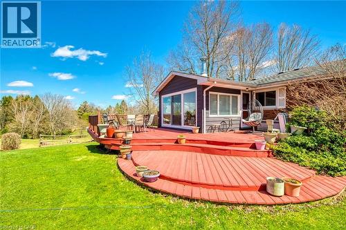 Rear view of house with a yard and a deck - 1215 Britannia Road, Burlington, ON 