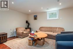 Living room with wood finished floors and recessed lighting - 