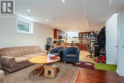 Living room featuring light wood-style floors and recessed lighting - 