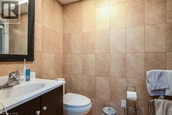 Half bath with tile walls and vanity - 