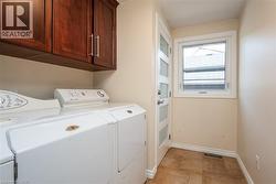 Laundry room with independent washer and dryer and cabinet space - 
