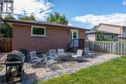 Back of house with a patio area and brick siding - 