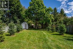 Fenced backyard with a storage unit - 