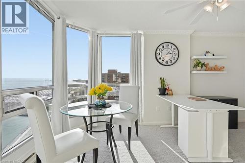 Dining space featuring light carpet, ceiling fan, and a water view - 2170 Marine Drive Unit# 1808, Oakville, ON - Indoor Photo Showing Dining Room