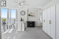 Office space with floor to ceiling windows, light colored carpet, ceiling fan, crown molding, and a textured ceiling - 