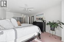 Bedroom with light carpet and ceiling fan - 