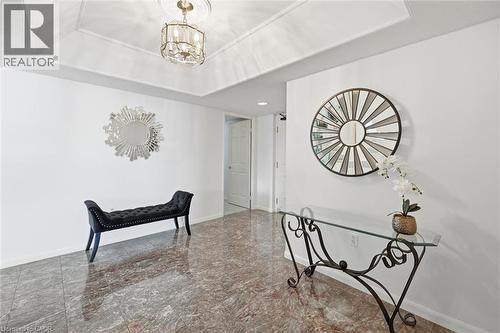 Corridor featuring baseboards and a chandelier - 2170 Marine Drive Unit# 1808, Oakville, ON - Indoor Photo Showing Other Room