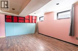 Unfurnished room with a textured ceiling, dark wood-style flooring, and a tray ceiling - 