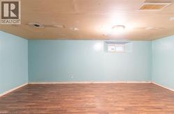 Basement featuring wood finished floors - 