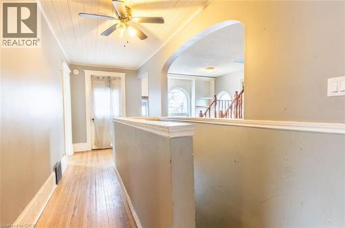 Corridor with arched walkways, light wood-type flooring, crown molding, and wood ceiling - 219 Erie Avenue, Brantford, ON - Indoor Photo Showing Other Room