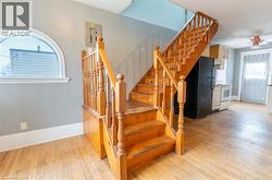 Staircase with wood-type flooring, healthy amount of natural light, and ceiling fan - 