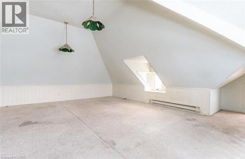 Additional living space with a baseboard radiator, lofted ceiling, a skylight, and wainscoting - 219 Erie Avenue, Brantford, ON - Indoor Photo Showing Other Room