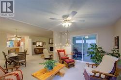 Carpeted living area with ceiling fan - 